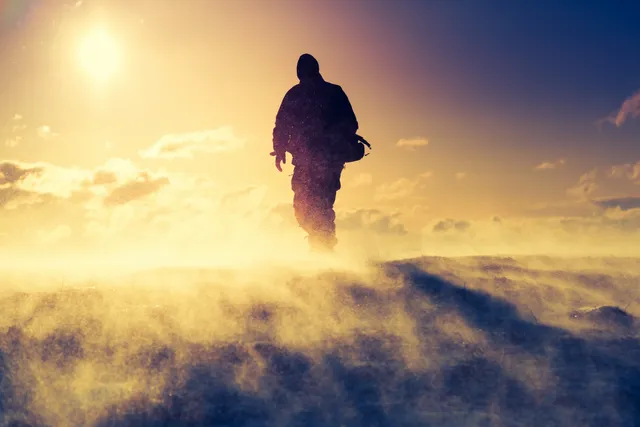 Silhouette of person in snowy blizzard.