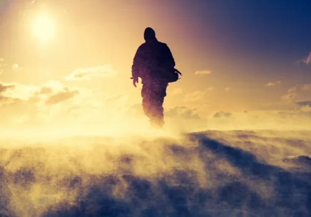 Silhouette of person in snowy blizzard.